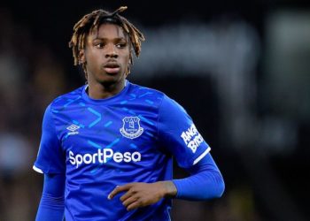 a soccer player with dreadlocks is running on the field.