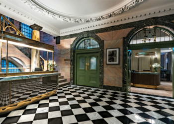 a black and white checkered floor in a hotel lobby.