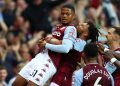 BIRMINGHAM, ENGLAND - SEPTEMBER 18: Leon Bailey of Aston Villa is congratulated by Tyrone Mings and teammates after his corner-kick led to their team's second goal, an own goal scored by Lucas Digne of Everton , during the Premier League match between Aston Villa and Everton at Villa Park on September 18, 2021 in Birmingham, England. (Photo by Michael Steele/Getty Images)