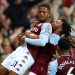 BIRMINGHAM, ENGLAND - SEPTEMBER 18: Leon Bailey of Aston Villa is congratulated by Tyrone Mings and teammates after his corner-kick led to their team's second goal, an own goal scored by Lucas Digne of Everton , during the Premier League match between Aston Villa and Everton at Villa Park on September 18, 2021 in Birmingham, England. (Photo by Michael Steele/Getty Images)